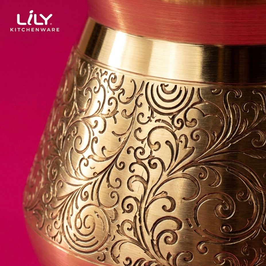 Close-up of etched floral pattern on brass lota